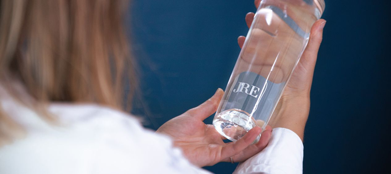 Plastic Bottle Of Drink Water And Reflection On Table With